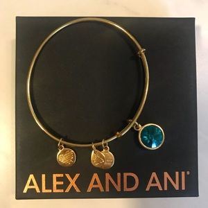Brand new. Alex and Ani blue topaz and gold bangle